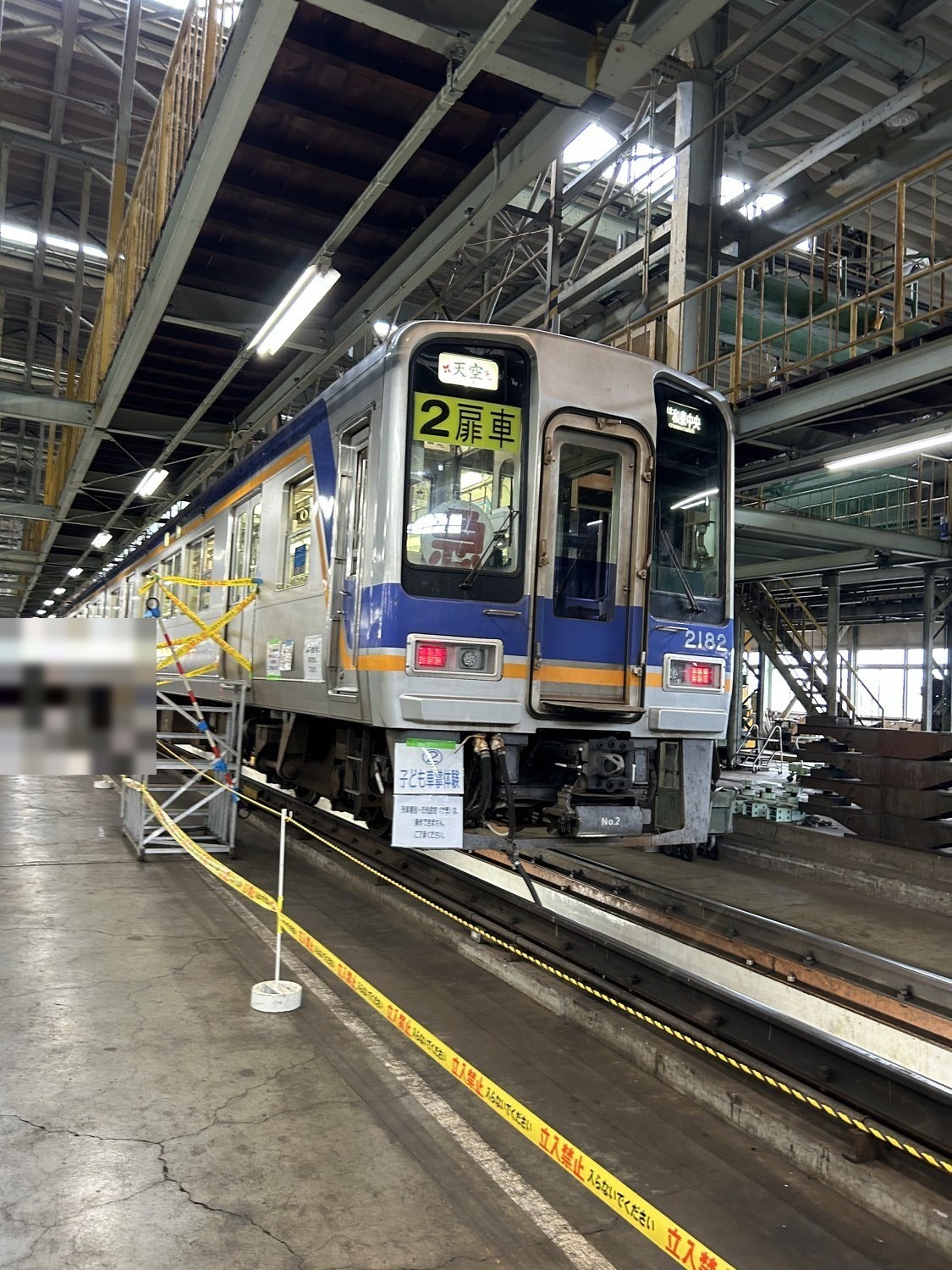 千代田工場に展示された南海2000系「天空」のヘッドマーク付き車両と、子ども車掌体験の案内